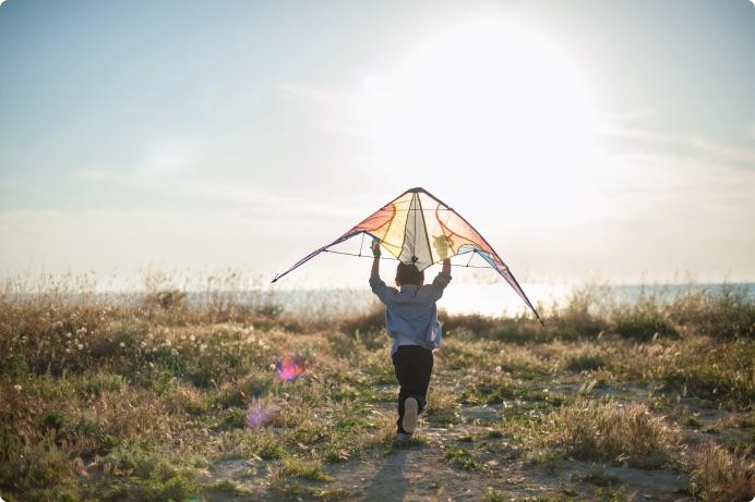 a person running with a kite