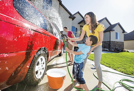 a person and a child washing a car