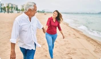 a man and a woman walking on a beach