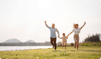 a family of three running outside together