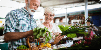 a senior couple looking at vegetables