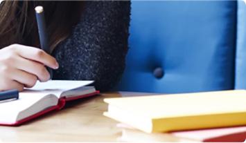 a person writing on a book