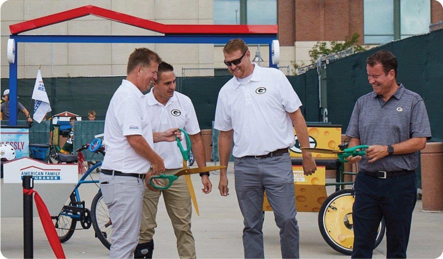 a group of men standing next to a bike