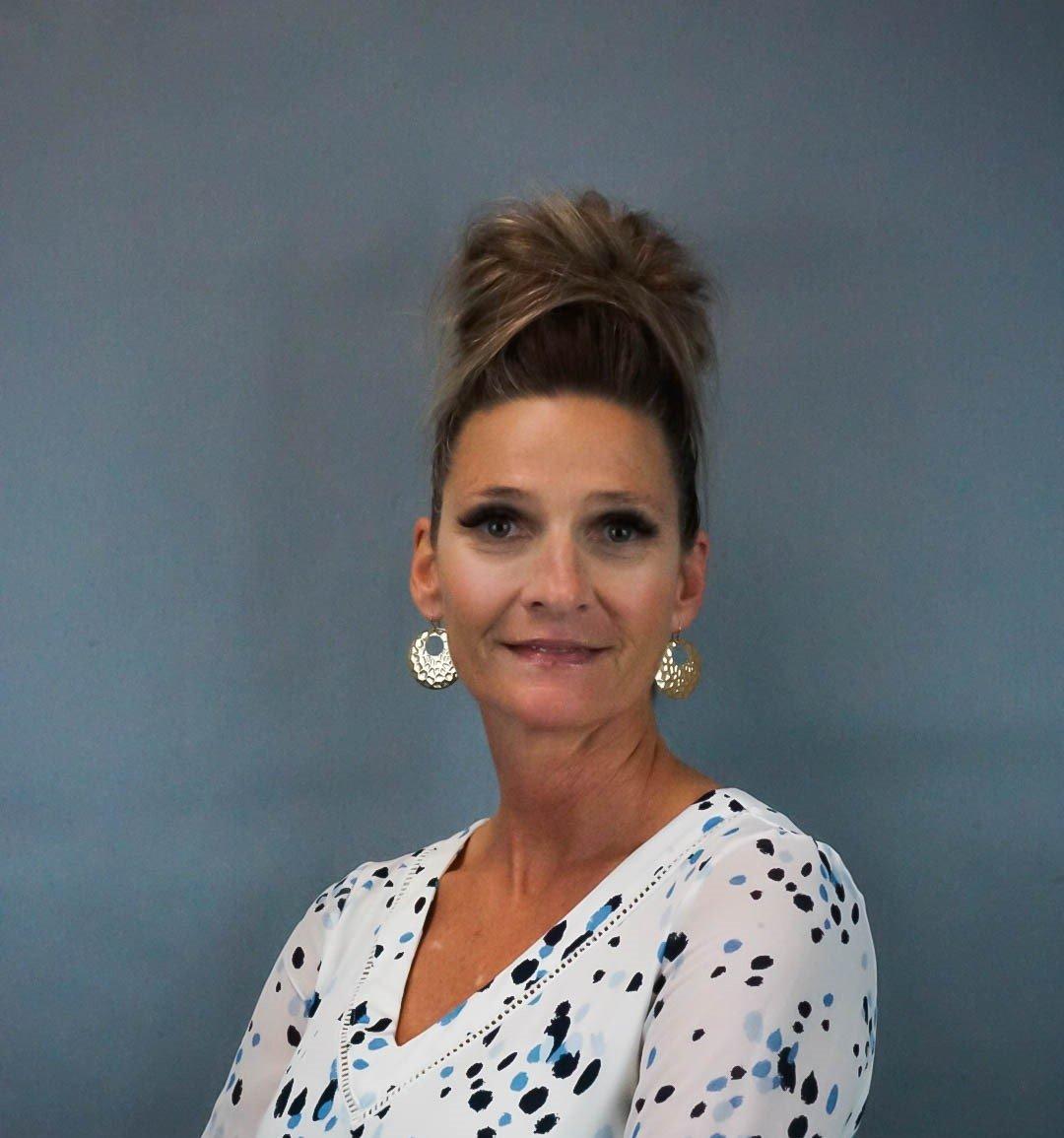 a woman with earrings smiling