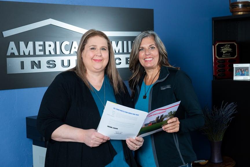 a couple of women holding a piece of paper