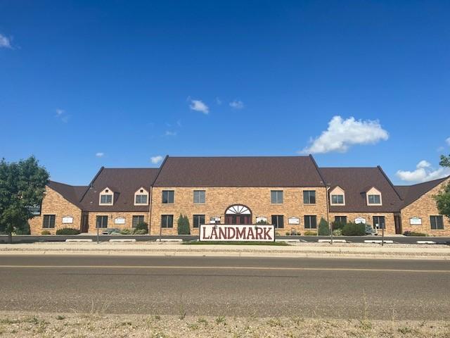 a large brick building with a sign in front of it