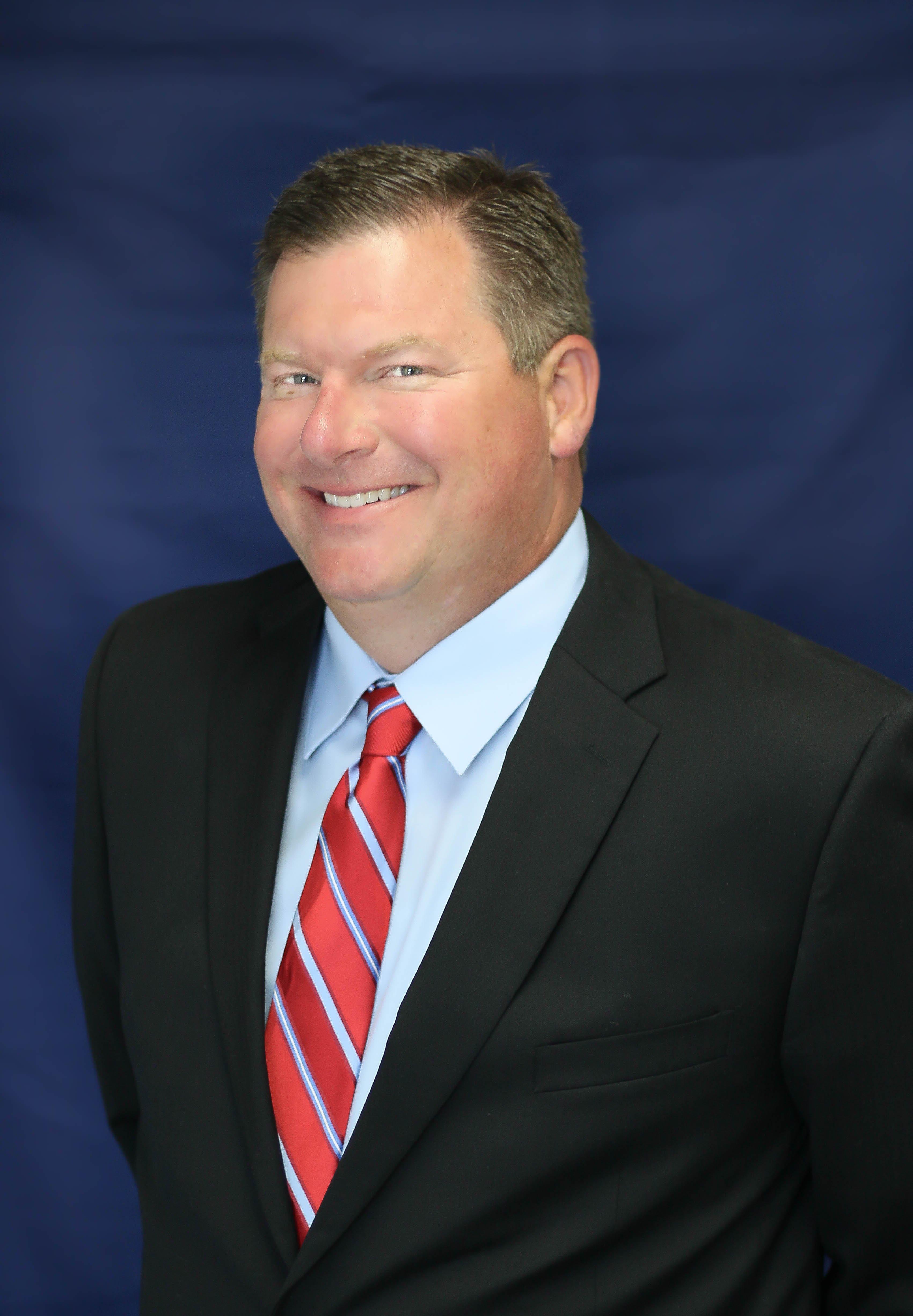 a man in a suit smiling