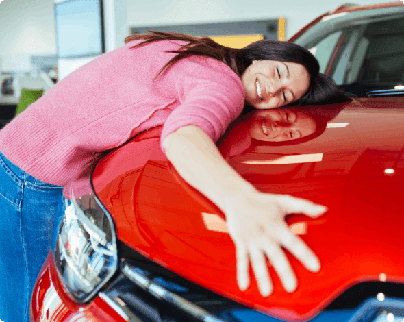 Happy customer hugging her new vehicle. 