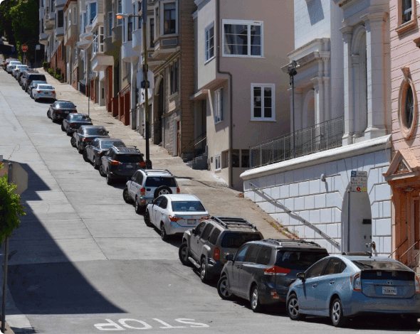 Cars parked uphill. 