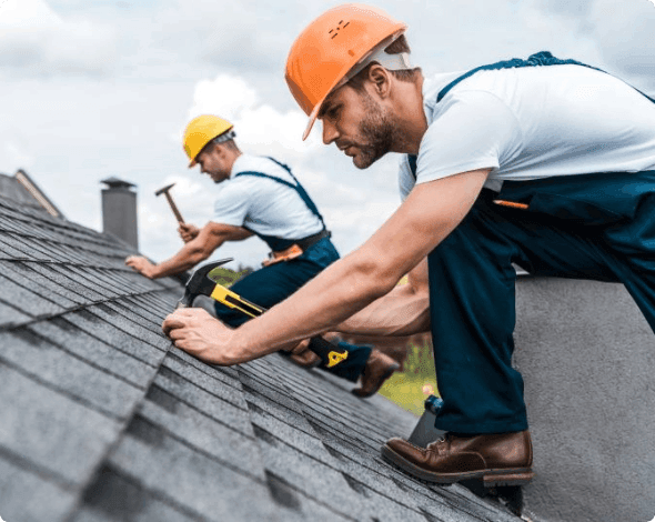 Workers installing new roofing shingles. 