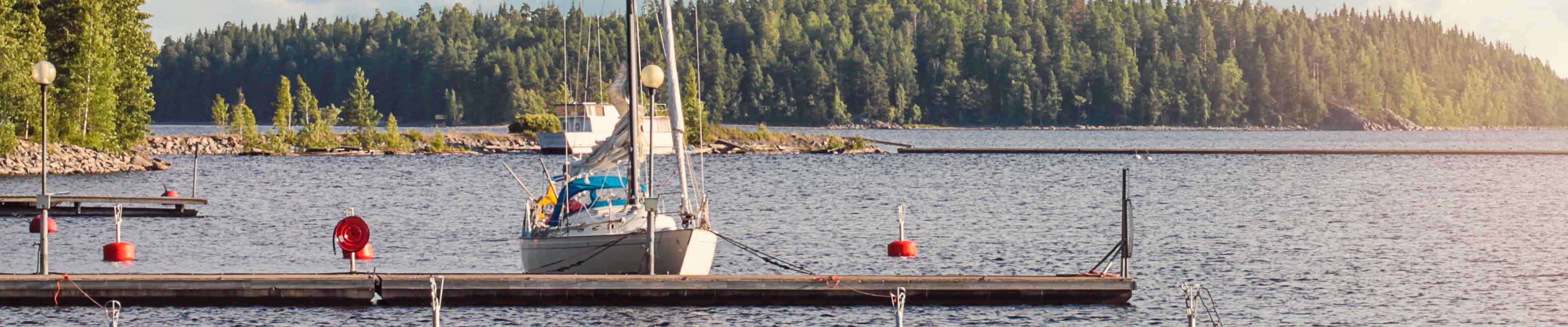 Sailboat docked by the pier. 