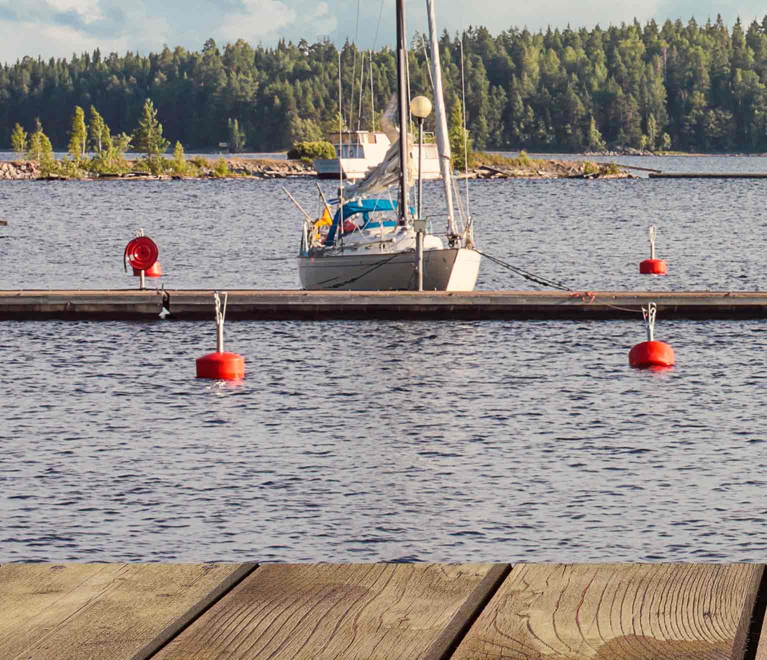 Sailboat docked by the pier. 