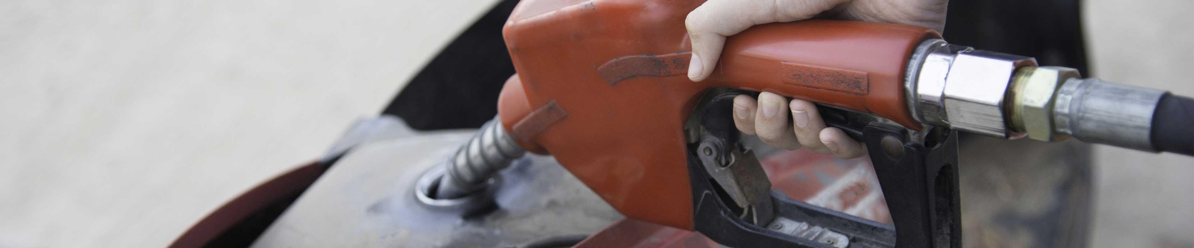 woman's hand fueling a motorcycle