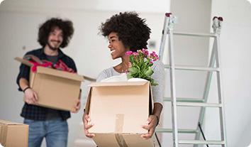 a man and woman carrying boxes