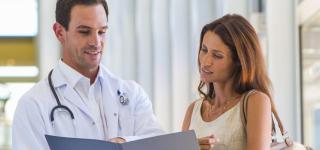 Patient looking at medical records with a doctor