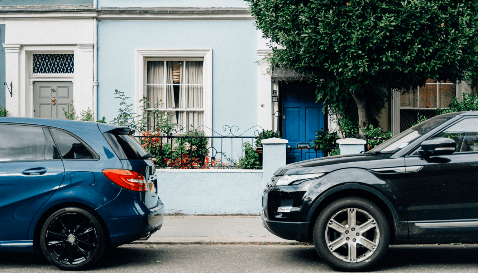 a couple of cars parked on the side of a street