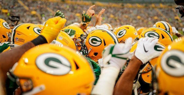 Packers players together with helmets on