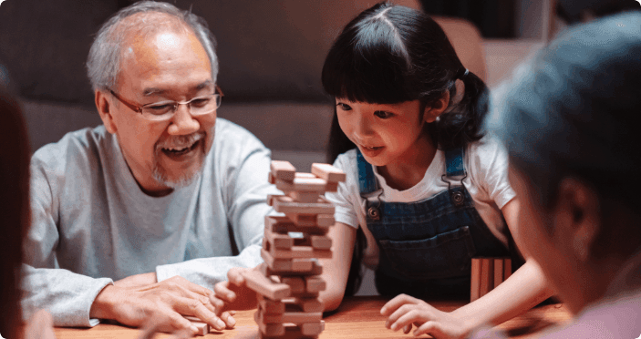 Grandparents playing a game with their grandchild.